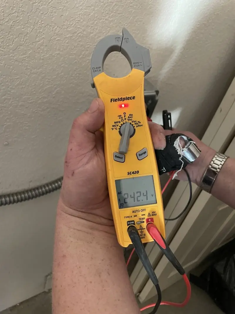 Voltage testing with clamp meter during Ceiling Fan Installation in Holly Springs